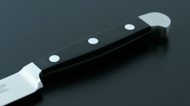 
                    Black, synthetic handle of the Parmesan knife Alpha