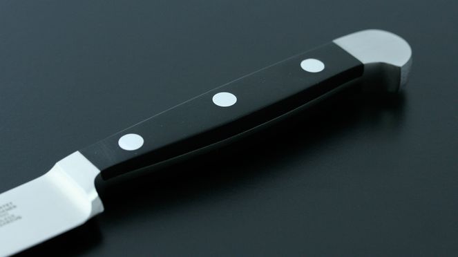 
                    The scalloped Santoku Alpha has a synthetic, black handle