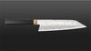 
                    La mitre dorée du Kiritsuke Ensei, inspirée du «habaki», est un collier métallique situé à la jonction entre le manche et la lame du sabre de samouraï